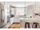 Bright kitchen featuring white cabinets, stainless steel appliances, and an island with bar seating at 2879 Shadow Lake Rd, Lafayette, CO 80026