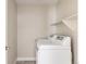 Functional laundry room with modern, white washer and dryer, and convenient shelving at 2879 Shadow Lake Rd, Lafayette, CO 80026