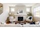 Inviting living room with fireplace, comfortable seating, hardwood floors, and plenty of natural light at 2879 Shadow Lake Rd, Lafayette, CO 80026