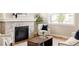 Cozy living room featuring a fireplace, wood floors, and a comfortable chair near a bright window at 2879 Shadow Lake Rd, Lafayette, CO 80026