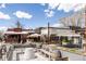View of Lulu's Wine House and other retail outlets in a busy outdoor shopping center with tables and umbrellas at 2879 Shadow Lake Rd, Lafayette, CO 80026