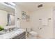 Bright bathroom with granite countertop, modern fixtures, and framed botanical wall art at 10826 Claire Ln, Northglenn, CO 80234