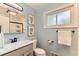 Bright bathroom with updated fixtures, framed artwork, and natural light at 10826 Claire Ln, Northglenn, CO 80234