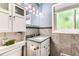 Well-lit bathroom featuring white cabinets, granite counters, and modern fixtures at 10826 Claire Ln, Northglenn, CO 80234