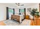 Comfortable bedroom featuring a ceiling fan, area rug, and windows with views at 10826 Claire Ln, Northglenn, CO 80234