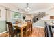 Dining room with modern chandelier, hardwood floors, and views of the staircase and front yard at 10826 Claire Ln, Northglenn, CO 80234