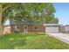 Charming two-story home with a well-manicured lawn, brick facade, and attached two car garage at 10826 Claire Ln, Northglenn, CO 80234