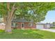Charming two-story home with a well-manicured lawn, brick facade, and attached two car garage at 10826 Claire Ln, Northglenn, CO 80234