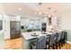Eat-in kitchen featuring stainless steel appliances, kitchen island with seating, and hardwood floors at 10826 Claire Ln, Northglenn, CO 80234