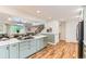 Bright, modern kitchen with a large island, hardwood floors, and stainless steel appliances at 10826 Claire Ln, Northglenn, CO 80234