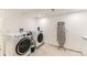 Functional laundry room with modern washer and dryer and ironing board at 10826 Claire Ln, Northglenn, CO 80234