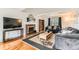 Comfortable living room with a fireplace, hardwood floors, large windows, and plenty of natural light at 10826 Claire Ln, Northglenn, CO 80234