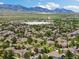 Scenic aerial view of a community nestled amongst nature, offering a tranquil setting with mountain views in the distance at 16753 W 61St Ln, Golden, CO 80403