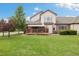 Backyard with well-maintained lawn and deck featuring retractable awning adding character and charm to the outdoor space at 16753 W 61St Ln, Golden, CO 80403