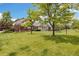 Expansive lawn surrounds the townhome, showcasing a well-kept outdoor space perfect for relaxation and recreation at 16753 W 61St Ln, Golden, CO 80403