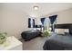 Bright bedroom with two beds, natural light, and coordinating blue curtains at 16753 W 61St Ln, Golden, CO 80403
