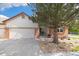 Traditional home with brick accents, a well-maintained lawn, and mature landscaping at 16753 W 61St Ln, Golden, CO 80403