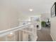 Bright upstairs hallway with white banister, natural light, and view to outdoors at 16753 W 61St Ln, Golden, CO 80403