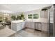 Bright kitchen with stainless steel appliances, light countertops, and an adjacent dining area at 16753 W 61St Ln, Golden, CO 80403