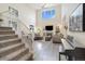 Bright living room with high ceilings, fireplace, and stylish staircase at 16753 W 61St Ln, Golden, CO 80403