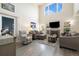Open living room with a fireplace, high ceilings, and ample natural light at 16753 W 61St Ln, Golden, CO 80403