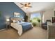 Primary bedroom with a blue accent wall, natural light, and a ceiling fan at 16753 W 61St Ln, Golden, CO 80403