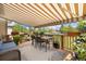 Outdoor patio with dining set and awning, creating a comfortable space for entertaining or relaxing in a backyard setting at 16753 W 61St Ln, Golden, CO 80403