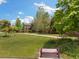 Community park featuring a paved walking path, bench, and lush greenery, perfect for leisurely strolls at 16753 W 61St Ln, Golden, CO 80403
