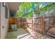 Private fenced backyard with mature trees, concrete patio, and updated air conditioner at 10693 W 63Rd Dr # 106, Arvada, CO 80004