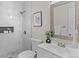 Bathroom with marble tiled walk-in shower and vanity with framed mirror at 10693 W 63Rd Dr # 106, Arvada, CO 80004