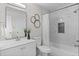 Bathroom with modern vanity, framed mirror, and tiled shower/tub at 10693 W 63Rd Dr # 106, Arvada, CO 80004