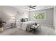 Comfortable bedroom boasts a ceiling fan, large window, and gray carpet at 10693 W 63Rd Dr # 106, Arvada, CO 80004