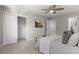 Spacious bedroom with ceiling fan, carpet, closet, and bright lighting at 10693 W 63Rd Dr # 106, Arvada, CO 80004
