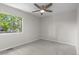 Light and airy bedroom with neutral tones, carpeted floor, ceiling fan, and natural light at 10693 W 63Rd Dr # 106, Arvada, CO 80004