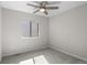 Bright, carpeted bedroom with ceiling fan and a large window at 10693 W 63Rd Dr # 106, Arvada, CO 80004