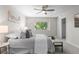 Bedroom with a ceiling fan, large window, and double closet at 10693 W 63Rd Dr # 106, Arvada, CO 80004