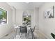 Charming dining area with open concept, stylish decor, and view to the living room at 10693 W 63Rd Dr # 106, Arvada, CO 80004