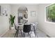 Bright dining area with stylish table set, modern decor, and archway to the kitchen at 10693 W 63Rd Dr # 106, Arvada, CO 80004