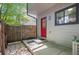 Charming entrance with a bright red door, stone pavers, and updated light fixture at 10693 W 63Rd Dr # 106, Arvada, CO 80004