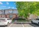 Charming brick and siding townhouse with lush front yard and assigned parking spaces at 10693 W 63Rd Dr # 106, Arvada, CO 80004