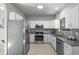Modern kitchen featuring stainless steel appliances, granite countertops, and ample cabinet space at 10693 W 63Rd Dr # 106, Arvada, CO 80004