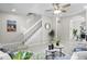 Open concept living room featuring a staircase, neutral decor, and archway to the dining area at 10693 W 63Rd Dr # 106, Arvada, CO 80004