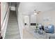 Spacious living room with stairway, open floor plan, fireplace, and ceiling fan at 10693 W 63Rd Dr # 106, Arvada, CO 80004