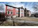 Red condominium building with trimmed windows, chimneys, and exterior staircase at 2686 E Otero Pl # 12, Centennial, CO 80122