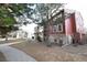Side view of red building, landscaping, and a paved walkway at 2686 E Otero Pl # 12, Centennial, CO 80122