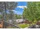 The upper deck overlooks a well-manicured backyard with views of the neighborhood at 11410 W 72Nd Pl, Arvada, CO 80005