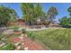 The manicured backyard features lush grass and mature trees for privacy at 11410 W 72Nd Pl, Arvada, CO 80005