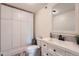 Bathroom features white cabinetry, a framed mirror, a toilet and ample storage space at 11410 W 72Nd Pl, Arvada, CO 80005
