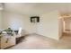 Carpeted bedroom with a desk, chair, and wall-mounted television at 11410 W 72Nd Pl, Arvada, CO 80005