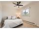 Cozy bedroom featuring a ceiling fan, plush carpet and bright window views at 11410 W 72Nd Pl, Arvada, CO 80005